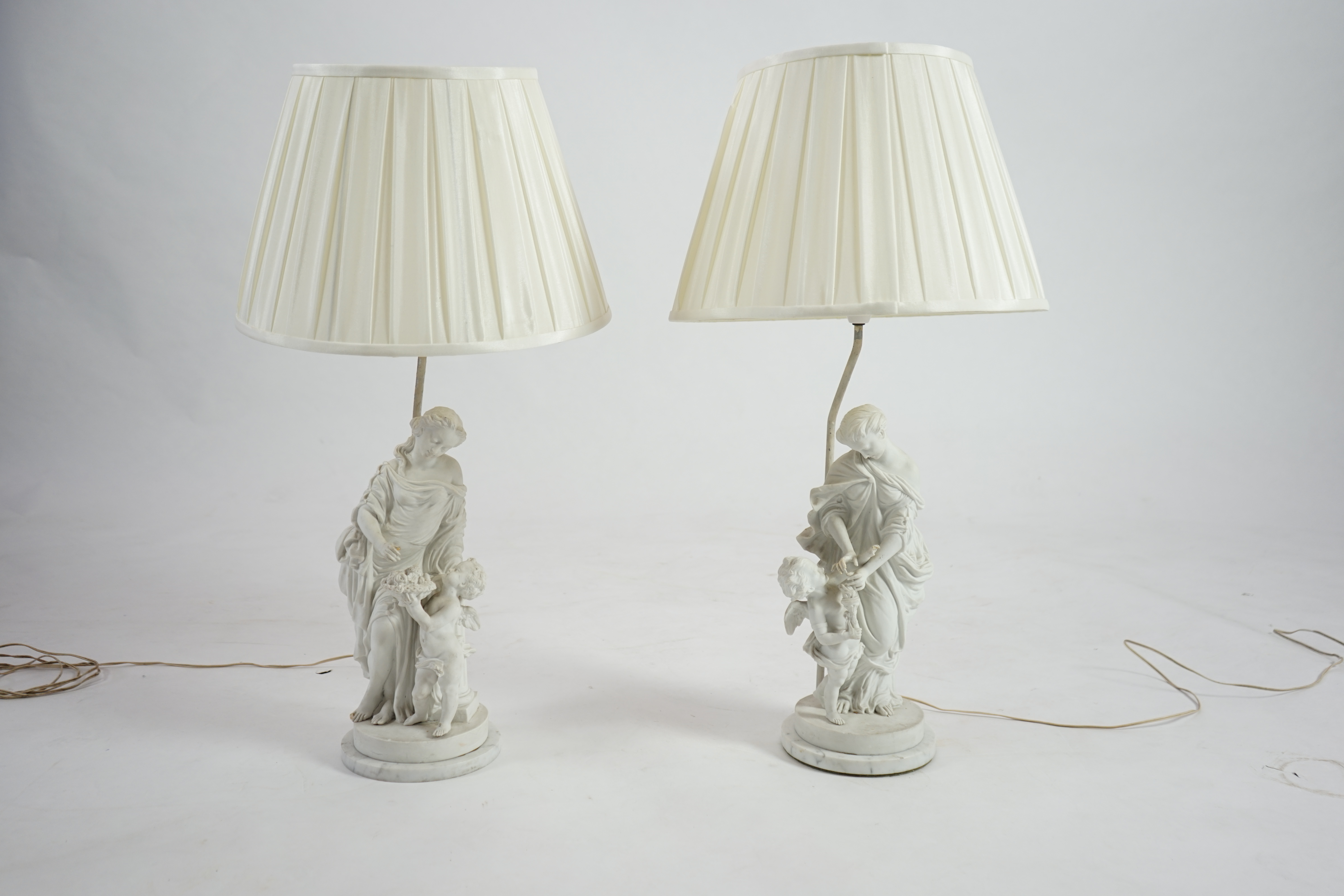 A pair of 19th century French bisque groups, depicting the seasons, Summer and Winter